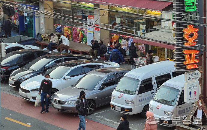 화성시 향남읍 한 마트 앞에 외국인들이 자가용을 주차한 뒤 불법 택시 호객행위를 위해 대기하고 있는 모습. 양효원기자