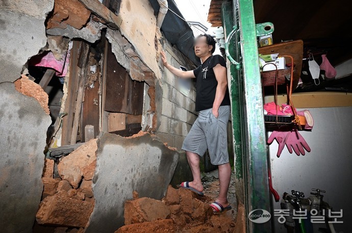 장마전선이 수도권지역으로 북상해 국지성 호우가 계속되며 최대 강수량 120mm를 기록한 9일 오후 수원시 팔달구 한 쪽방촌 골목에서 호우로 인해 건축물 외벽이 무너져 있다. 인근 주민들은 "무너진 벽이 비가 더 오면 완전히 붕괴될까 불안에 떨며 공공기관에 연락했지만 아무런 조치가 없다."고 전했다. 김경민기자