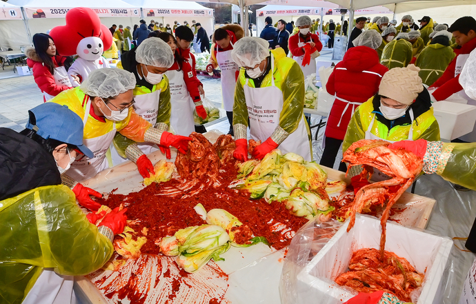 18일 오후 광명시 하안동 광명시민체육관에서 열린 2025년 따뜻한 겨울나기 지원사업 전달식 및 김장김치 담기 봉사활동에 참가한 정순욱 광명시 부시장, 김효진 경기 사랑의열매 사무처장, 강기태 사회복지협의회 회장, 유복순 아너 소사이어티 대표 등 시민들이 김치를 담그고 있다. 임채운기자